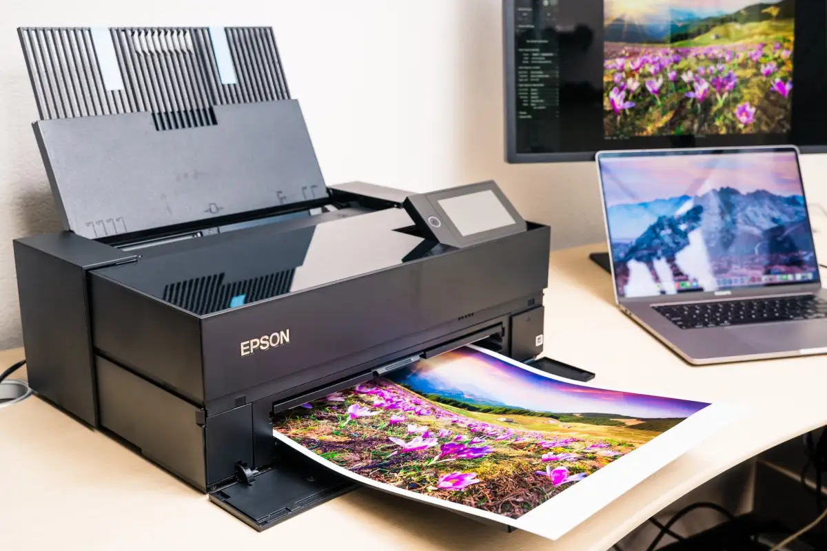 Epson SureColor P700 printer on desk with prints