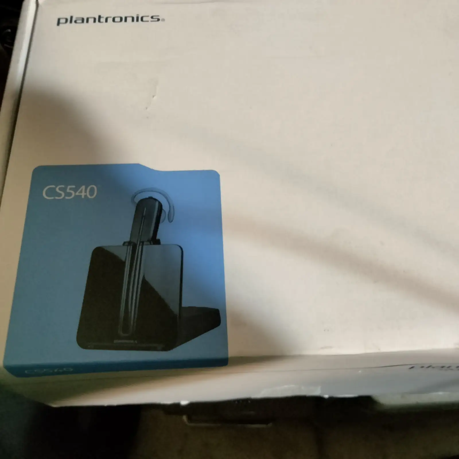 Plantronics CS540 wireless headset on charging base