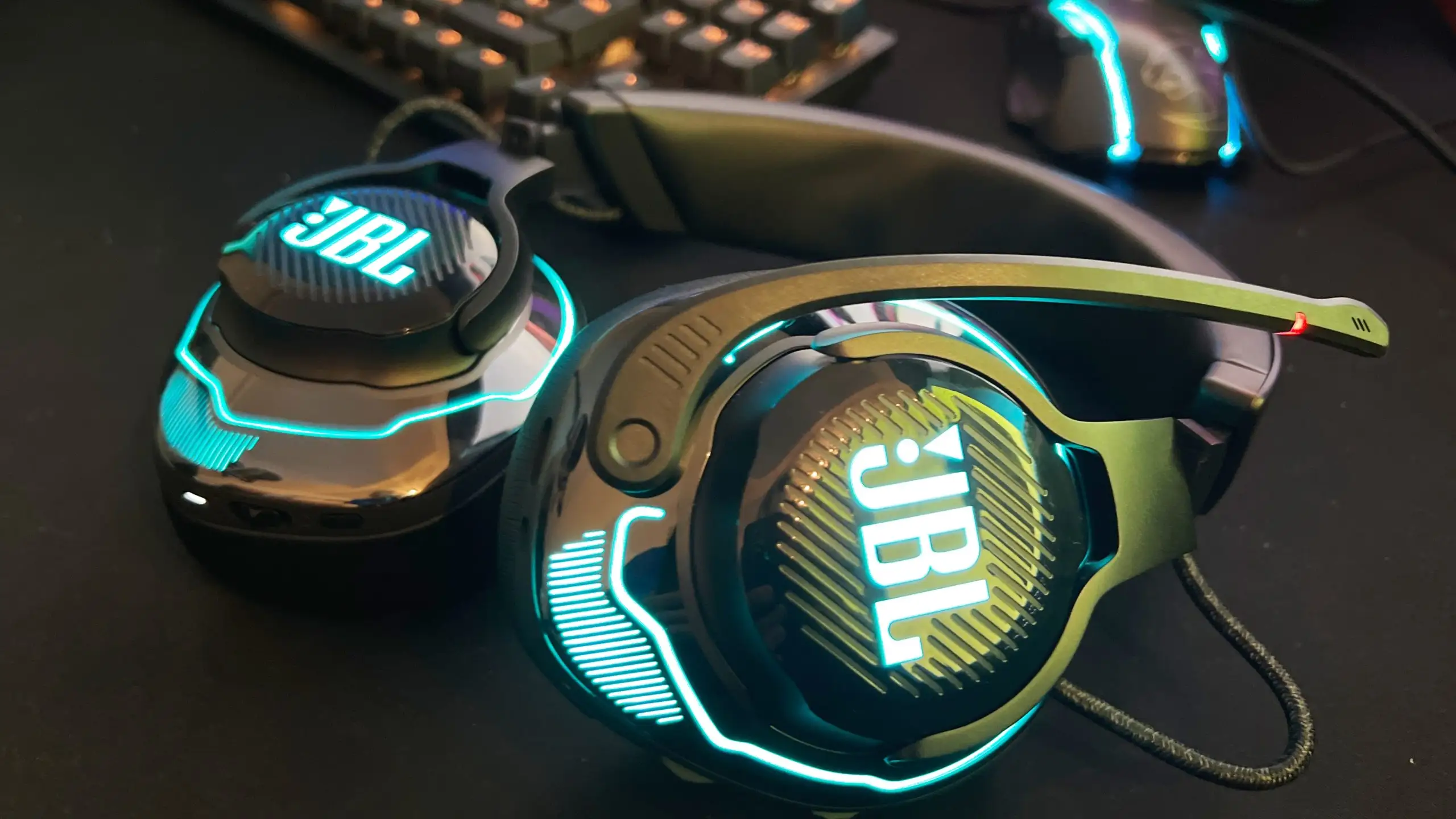 JBL Vibe Beam earbuds on desk with case open